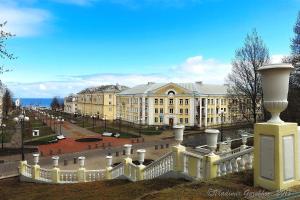 a large building with a white fence in front of it at Majakovski Junior Suite in Sillamäe