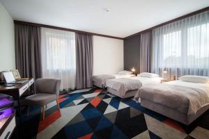Postel nebo postele na pokoji v ubytování Vulcan Hotel