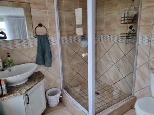 a bathroom with a shower and a sink at Diaz 11 Unit 15 in Jeffreys Bay +21 photos