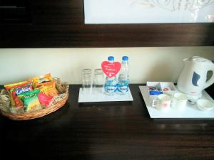 a table with a basket of food and drinks on it at The Samilton in Kolkata