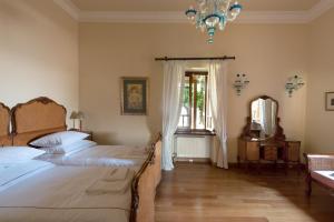 Postel nebo postele na pokoji v ubytování Montofoli Wine Estate + 89 fotografií