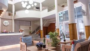 a lobby of a building with tables and chairs at S2 Hotel - SHA Plus Certified in Bangsaen