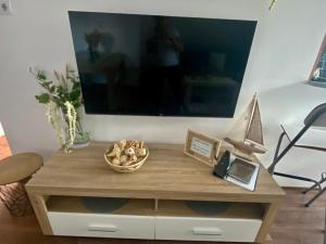 a table with a bowl of mushrooms and a boat on it at Munkácsy Apartmanok in Balatonfenyves +15 photos