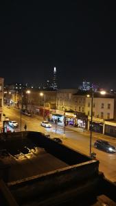 a city at night with cars parked in a parking lot at Marahanata Jadwin 1 BEAUTIFUL 1 BED ROOM FLAT in London
