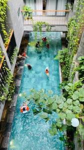 a pool of water with people swimming in it at VernalHome Boutique Danang in Danang
