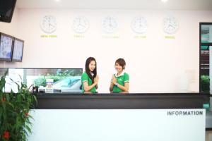 two girls standing behind a counter with clocks on the wall at Pattara Place in Chiang Mai +21 photos