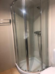 a shower with a glass door in a bathroom at Apartmento studio boho a 1 minuto del puerto y la playa! in Jávea +16 photos