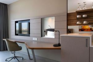 a home office with a desk and a mirror at Radisson Blu Hotel & Residence Maputo in Maputo