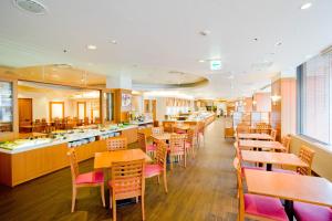 a restaurant with wooden tables and chairs and a cafeteria at Sapporo Tokyu REI Hotel in Sapporo