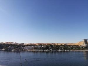 a large body of water with a lighthouse at Philae Hotel Aswan in Aswan