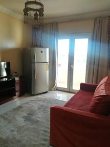 a kitchen with a refrigerator and a couch in a room at Philae Hotel Aswan in Aswan