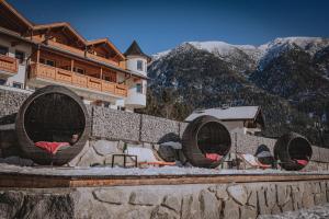 a building with two large fans on a wall with mountains at loisi's Boutiquehotel in Achenkirch