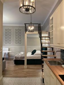 a room with a bunk bed and a kitchen at Starowiślna Center Apartments in Krakow