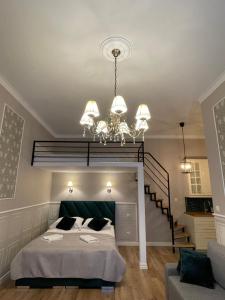 a bedroom with a large bed and a chandelier at Starowiślna Center Apartments in Krakow