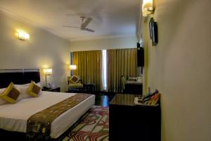 a hotel room with a bed and a window at The Wall Street Beacon, Jaipur in Jaipur