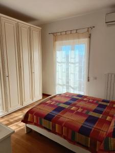 sypialnia z łóżkiem i oknem w obiekcie Gloriapartment w mieście Civitavecchia