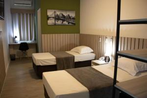En eller flere senge i et værelse på Hotel Jardim Sul