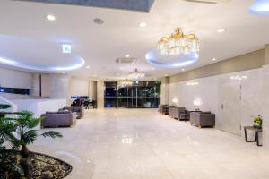 an office lobby with chairs and a chandelier at Shin Shin Hotel Jeju Worldcup in Seogwipo