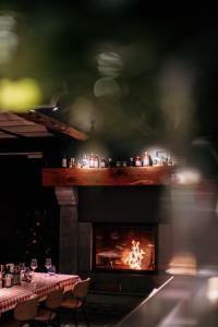 a fireplace with a table and chairs in front at Hotel Saint-Amour in Durbuy