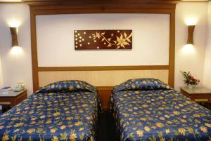 Ein Bett oder Betten in einem Zimmer der Unterkunft Royal Twins Palace Hotel
