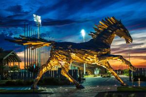 a statue of a horse in front of a building at X-BIONIC Hotel in Šamorín