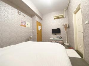 Ein Bett oder Betten in einem Zimmer der Unterkunft Yixiang Spring Travel