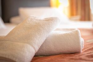 a roll of toilet paper sitting on top of a bed at Skegness The Royal Hotel in Skegness