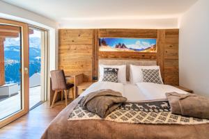 A bed or beds in a room at Luech da Perteut - Panorama and Wellness