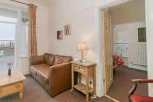 a living room with a couch and a table at Skegness The Royal Hotel in Skegness