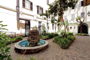 a fountain in the courtyard of a building at Lucky Holidays in Rome