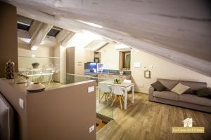 eine Küche und ein Wohnzimmer mit einem Sofa und einem Tisch in der Unterkunft La Casa dell'Olmo - Suite Apartment Cuneo in Cuneo