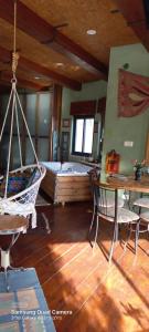 a room with a hammock and a room with a bed at קטלב kta-love in Kammon