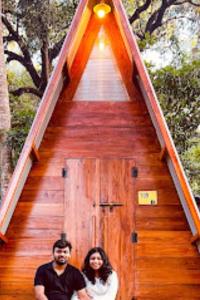 a man and a woman standing in front of a staircase at The Hosteller Goa, Anjuna in Anjuna