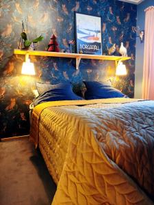 a bedroom with a large bed with a colorful wallpaper at Boka Borgafjäll in Borgafjäll