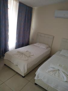 Postel nebo postele na pokoji v ubytování Romeo Beach Hotel