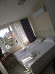 Postel nebo postele na pokoji v ubytování Romeo Beach Hotel