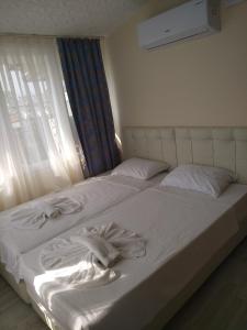 Postel nebo postele na pokoji v ubytování Romeo Beach Hotel