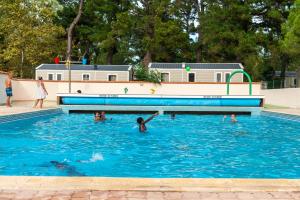 a group of people playing in a swimming pool at Camping maeva Club Le Lagon d'Argelès in Argelès-sur-Mer