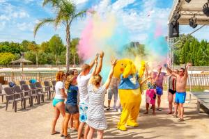 a group of children watching a group of people with a yellow duck mascot at Camping maeva Club Le Lagon d'Argelès in Argelès-sur-Mer +24 photos