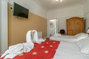 a hotel room with two beds with towels at Skegness The Royal Hotel in Skegness