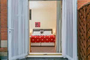 a bedroom with a bed with a red blanket at Skegness The Royal Hotel in Skegness