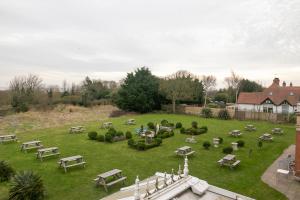a park with tables and benches on the grass at Skegness The Royal Hotel in Skegness