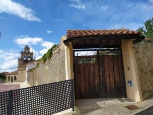 une porte menant à un bâtiment avec une porte en bois dans l'établissement Casa Almenara, à Almenara de Tormes