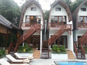 a villa with stairs and a swimming pool at Mojo Resort Canggu in Canggu