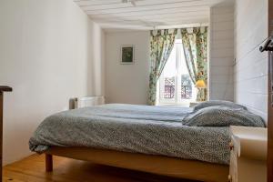 a bedroom with a bed and a window at La Gleyzette in Vogüé