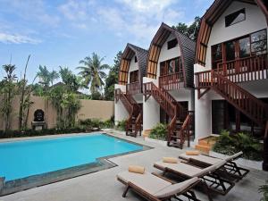 an image of a house with a swimming pool at Mojo Resort Canggu in Canggu