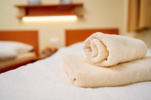 a towel animal sitting on top of a bed at Penzión Pod Babou in Omšenie