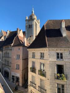 a group of buildings in a city with a tower at Les Tiercelines in Dole +14 photos
