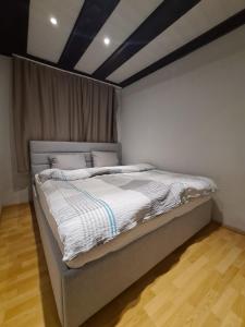 a bedroom with a bed with a black and white comforter at Koper step to the sea in Koper