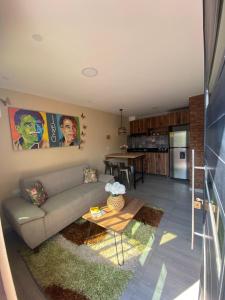 a living room with a couch and a table at Apartaestudios - Casa Tamarindo in Aracataca +9 photos